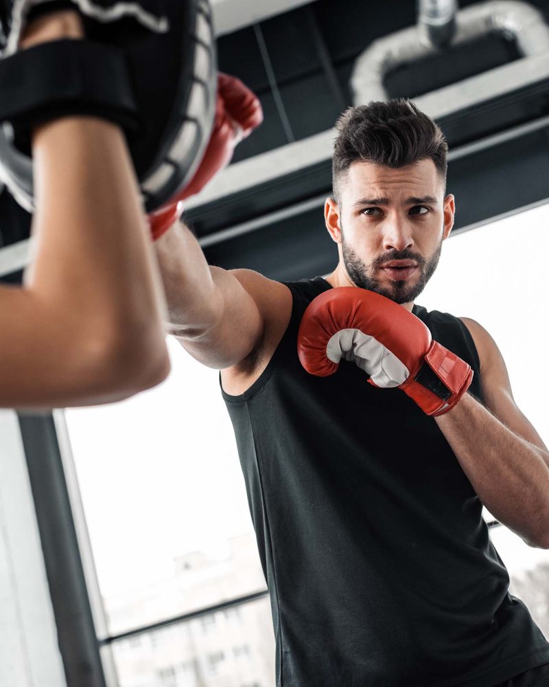 partial-view-of-trainer-and-male-boxer-in-boxing-g-3Q48B4R.jpg